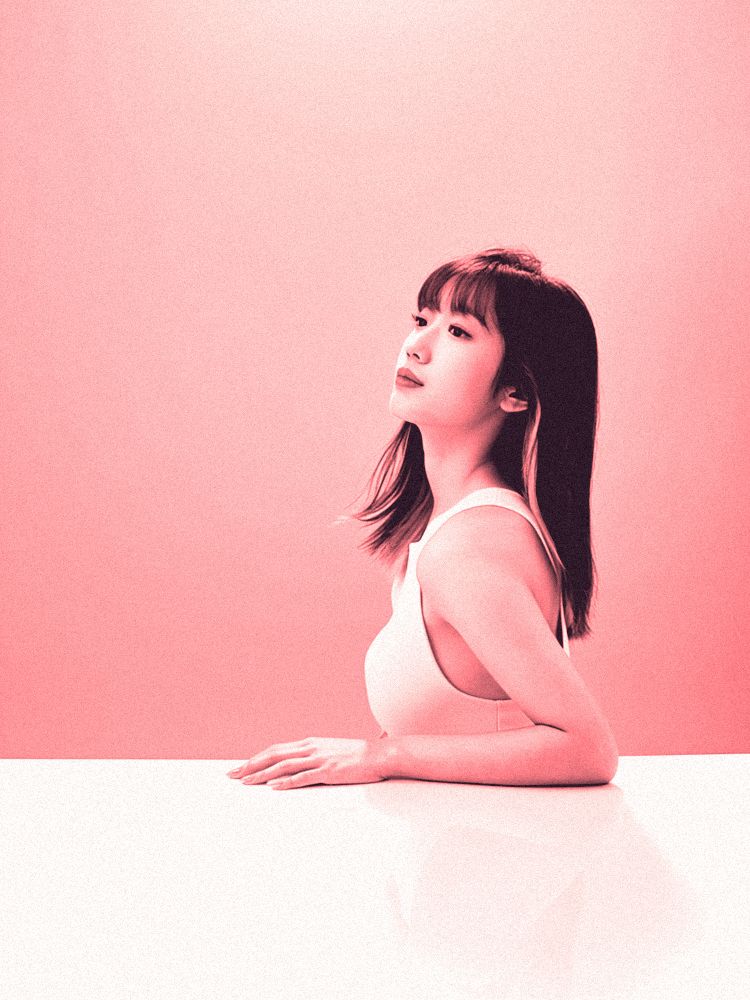 Portrait of Tia Xiao in profile, printed as a coral duotone